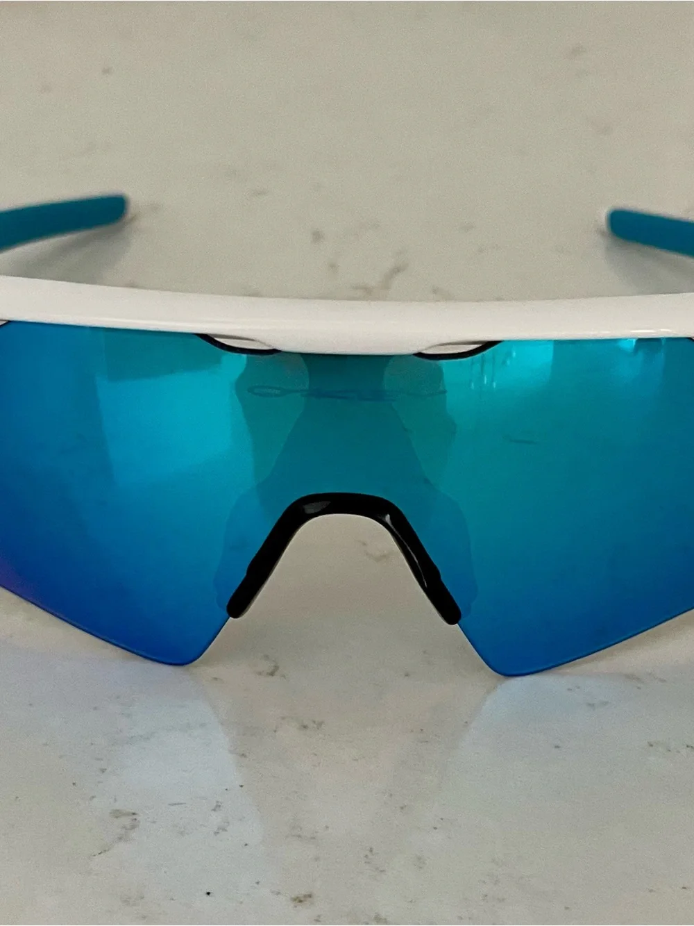 Oakley White Frame Sunglasses with Blue Lenses and Blue Temple Tips